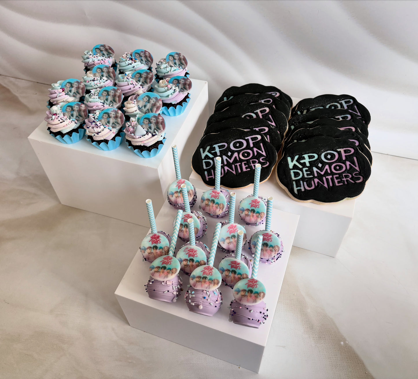 Decorative cookies with themed designs on a white surface